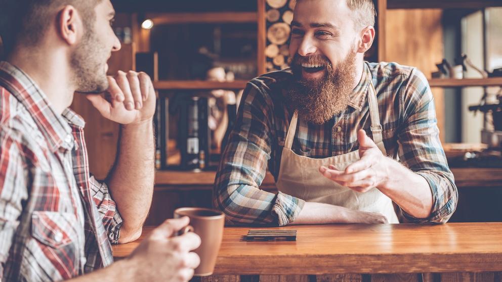 bartender and customer laughing at bar